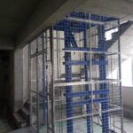 Cargo lift installed between two floors in a warehouse