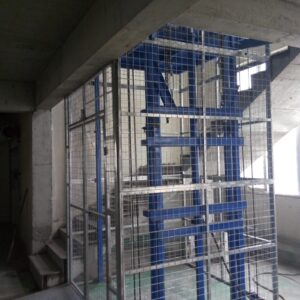 Cargo lift installed between two floors in a warehouse
