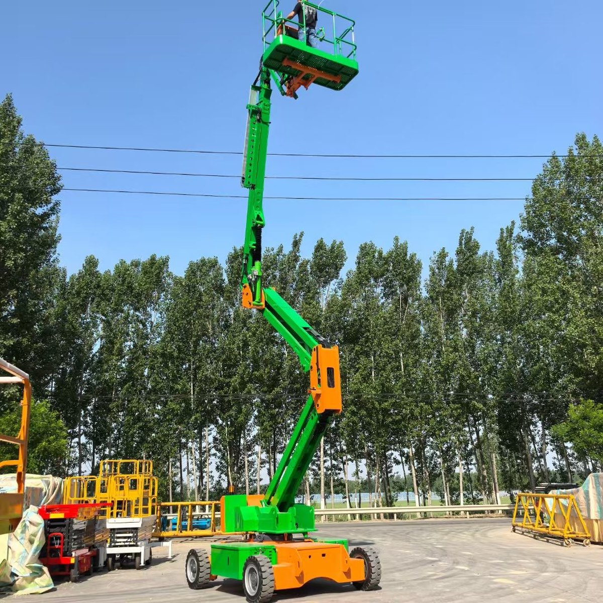 What Is Up-and-Over Clearance on a Boom Lift, and How Do You Read It? Articulated boom lift reaching over an obstacle